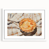 Abstract art print of assorted pastries in soft pastel shades, framed in white, ideal for dining room decor.