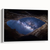 Framed canvas artwork depicting a serene landscape with canyons, featuring vibrant hues of orange and blue, set against a white background for a modern aesthetic. Ideal for home decor enthusiasts seeking nature-inspired art.