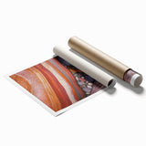 Vibrant rolled print showcasing a desert landscape with warm hues of orange and yellow, ideal for home decor or office spaces, presented in a protective cardboard tube.