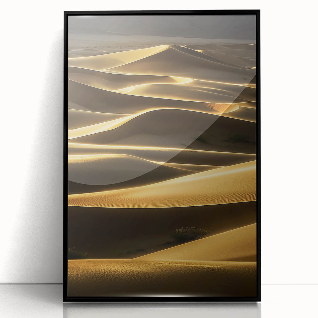 Framed acrylic artwork showcasing a serene landscape of rolling dunes in soft beige and golden hues, set in a sleek black frame, ideal for modern home decor.