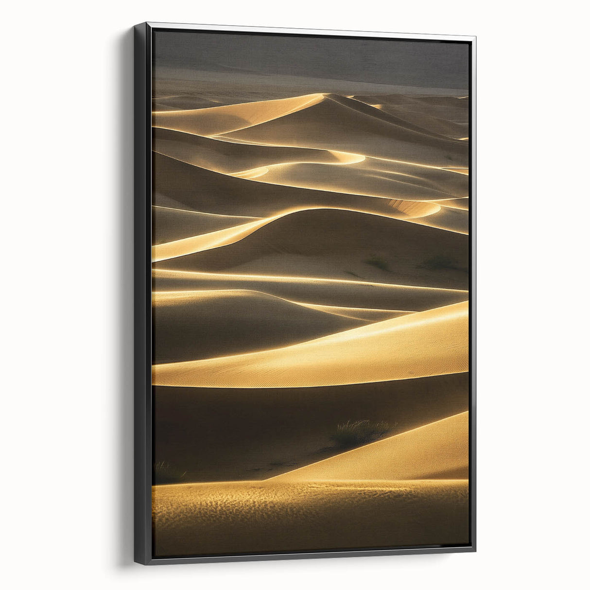 Framed canvas artwork showcasing a serene landscape of rolling sand dunes in warm tones, presented with a sleek black frame, perfect for modern décor.