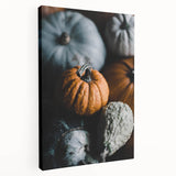 Side view of a large stretched canvas depicting a fall landscape with warm orange and red tones.