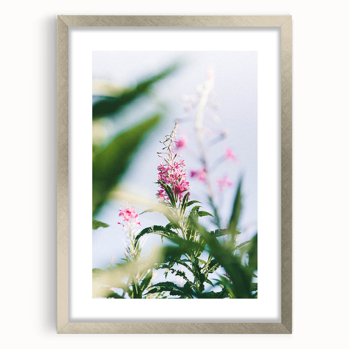 Textured abstract art print in soft green and yellow, framed in silver, ideal for bedroom decor.