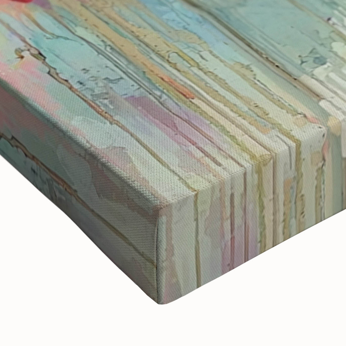 Close-up of a stretched canvas artwork showcasing vibrant abstract floral designs in shades of blue, pink, and yellow, perfect for modern home decor.