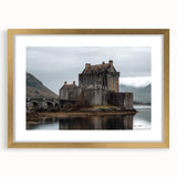Elegant gold-framed landscape artwork showcasing a picturesque castle scene, complemented by a mat for added sophistication. Ideal for home decor or gallery display.