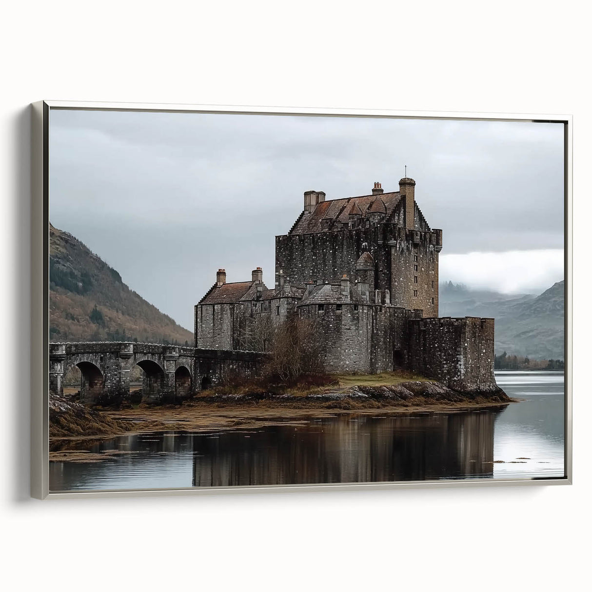 Framed canvas artwork depicting a serene landscape with a majestic castle, elegantly bordered in silver, showcasing intricate details and vibrant colors. Perfect for enhancing home decor.