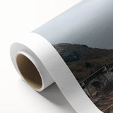 Rolled canvas artwork depicting a vibrant landscape with a majestic castle surrounded by lush greenery, ideal for home decor. Perfect for art enthusiasts.