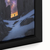 Close-up view of a framed canvas depicting a dramatic landscape with rugged cliffs and vibrant colors, ideal for enhancing modern home decor.