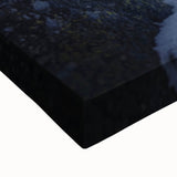 Close-up of a vibrant stretched canvas artwork depicting dramatic cliffs and serene landscapes, showcasing intricate details and rich colors, perfect for modern home decor.