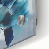 Vibrant abstract acrylic splatter art on glass, showcasing a dynamic interplay of colors including blues, yellows, and reds, perfect for modern decor.