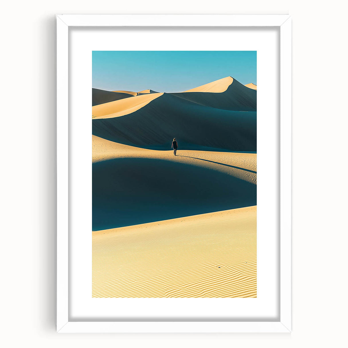 Framed landscape artwork showcasing serene sand dunes under a clear blue sky, featuring a white mat for an elegant presentation, ideal for home decor.