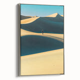 Framed canvas art depicting serene sand dunes in warm hues, showcasing a silver frame from the side, perfect for modern home decor and interior design aesthetics.