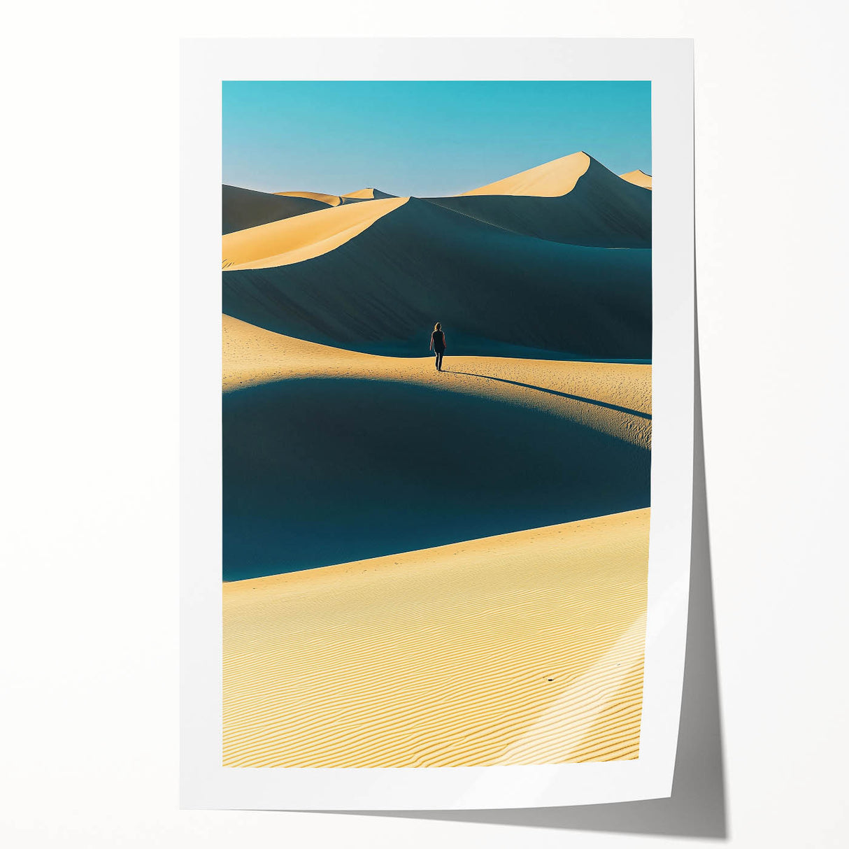 Landscape print showcasing rolling sand dunes under a vibrant sunset, emphasizing warm golden and orange hues, rolled and ready for framing or display.