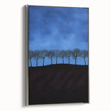 Framed canvas artwork depicting a serene landscape with lush green fields and a vibrant blue sky, showcased in a sleek silver frame, ideal for home decor.