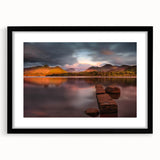 Abstract art print of Cumbria's landscape in vibrant colors on a large textured canvas, framed in black.
