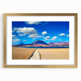Extra large abstract art print of a Bolivian landscape in textured hues of gold and blue, framed with a mat.