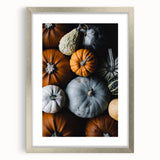 Textured abstract art print featuring warm autumnal hues on a silver-framed canvas, ideal for bedroom decor.