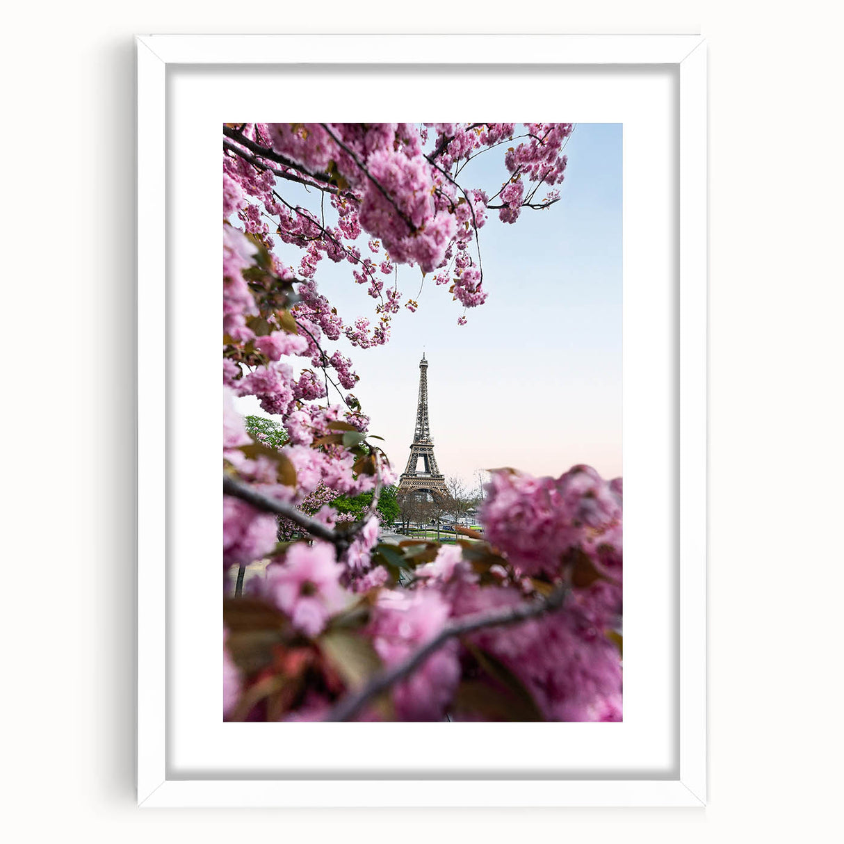 Abstract art print featuring swirling green and pink colors on a white framed canvas, ideal for bedroom or dining room decor.