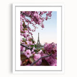 Abstract art print featuring swirling green and pink colors on a white framed canvas, ideal for bedroom or dining room decor.