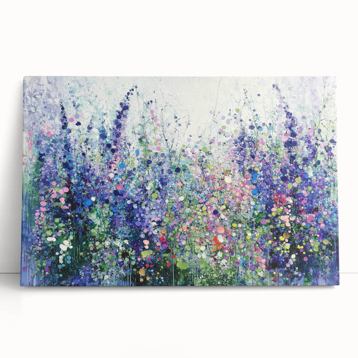 Abstract floral canvas art with vibrant colors, showcasing intricate designs and textures, leaning against a white wall, perfect for modern home decor.