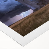 Rolled canvas artwork showcasing a picturesque landscape with a majestic castle set against a vibrant sunset, elegantly packaged in a protective tube for easy storage.