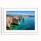 Framed landscape artwork showcasing dramatic cliffs and ocean views, presented with a white mat for an elegant finish, perfect for home decor.