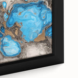 Close-up of a framed abstract canvas artwork showcasing vibrant blue and orange splatter patterns, perfect for modern home decor and artistic accents. This piece adds a dynamic touch to any living space or gallery wall.