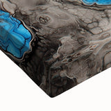 Close-up of a vibrant abstract splatter design on stretched canvas, showcasing dynamic colors of blue, yellow, and red, perfect for modern home decor.