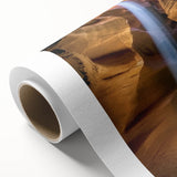 Vibrant rolled canvas depicting a stunning landscape of canyons with rich colors and intricate details, ideal for home decor and art enthusiasts. Packaged securely in a protective cardboard tube, this artwork adds a touch of natural beauty to any space.