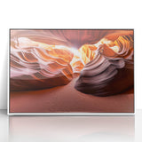 Framed acrylic artwork depicting a serene desert landscape with warm tones of orange and beige, featuring rugged mountains and a clear blue sky, perfect for home decor.