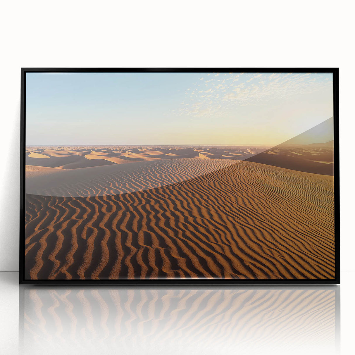 Framed acrylic artwork depicting serene sand dunes under a clear sky, featuring a sleek black frame, ideal for modern home decor and landscape art enthusiasts.