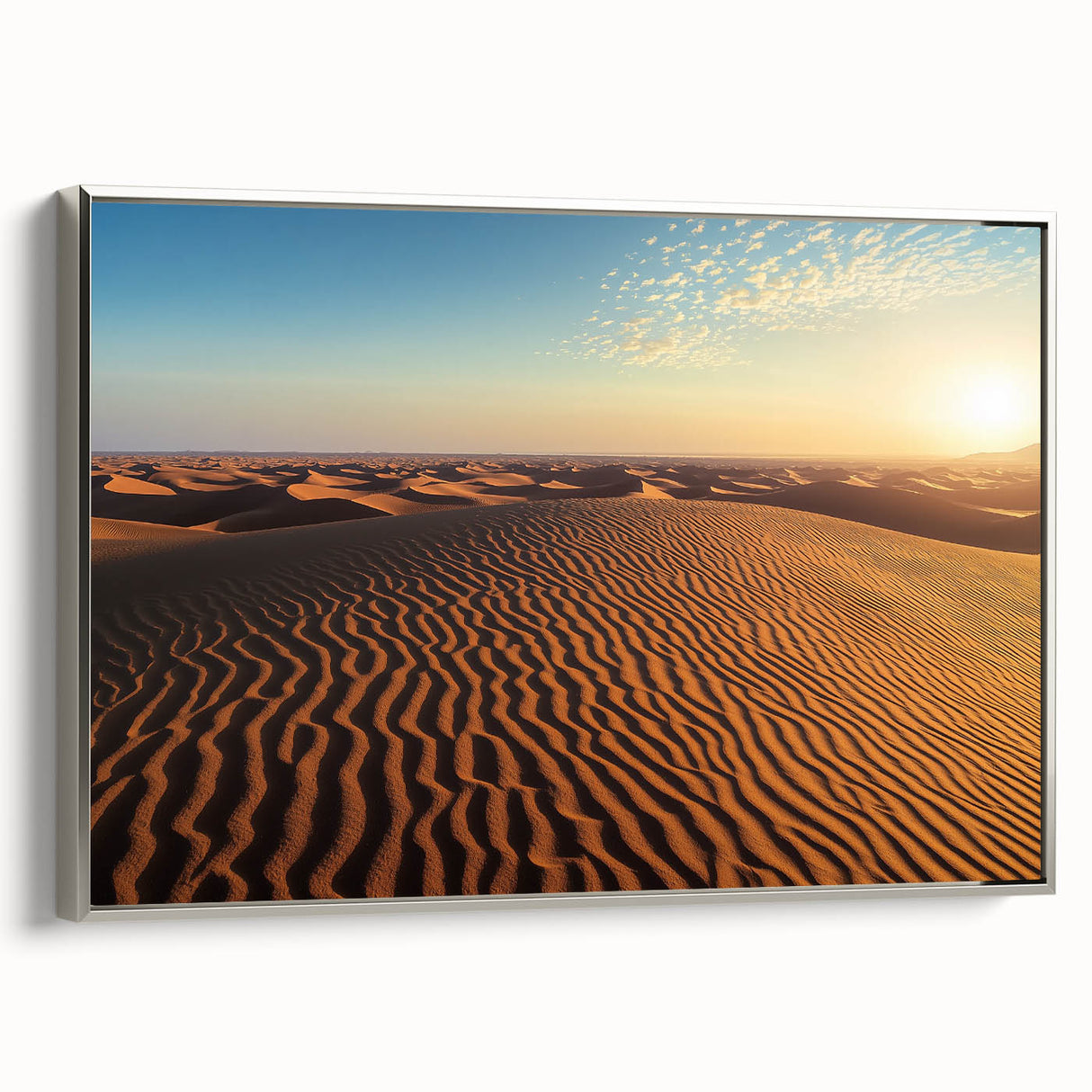 Framed canvas artwork showcasing serene desert dunes in soft beige and gold tones, elegantly displayed from a side view with a sleek silver frame. Ideal for modern home decor.