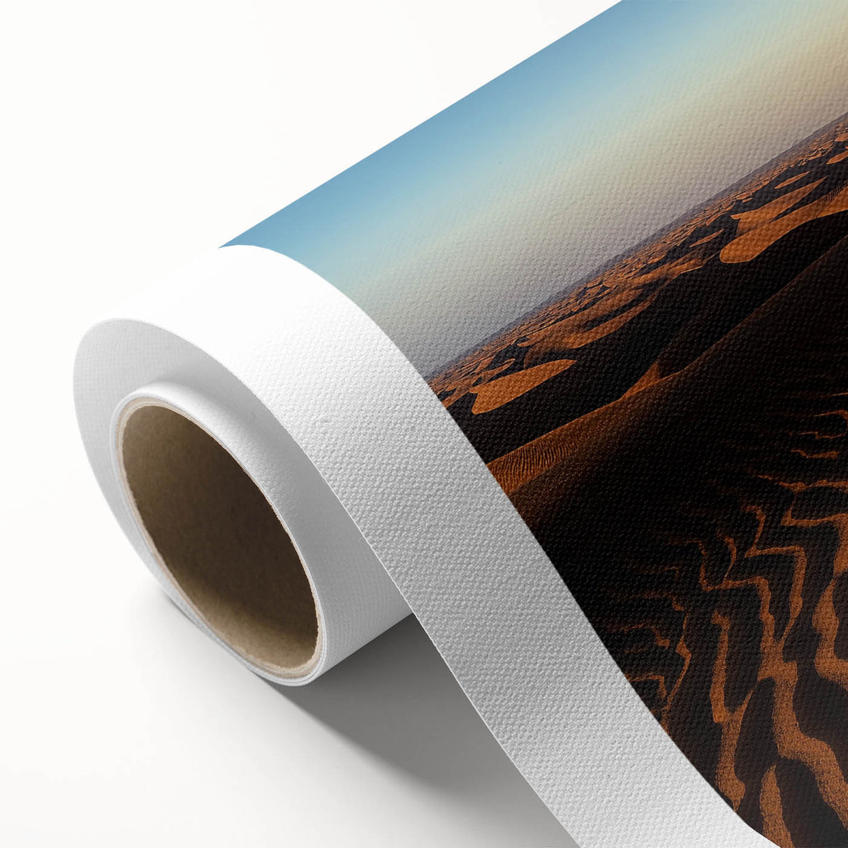 Rolled canvas artwork depicting serene desert dunes under a soft sunset sky, showcasing warm beige and orange tones, ideal for modern home decor.
