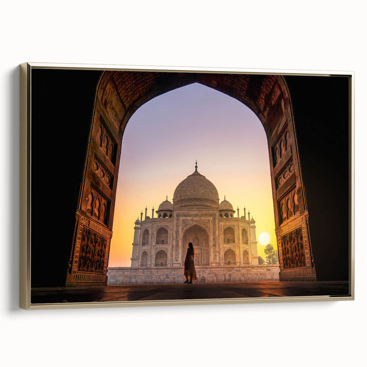 Framed canvas featuring a vintage-style landscape painting of an Indian scenery in gold and black tones.