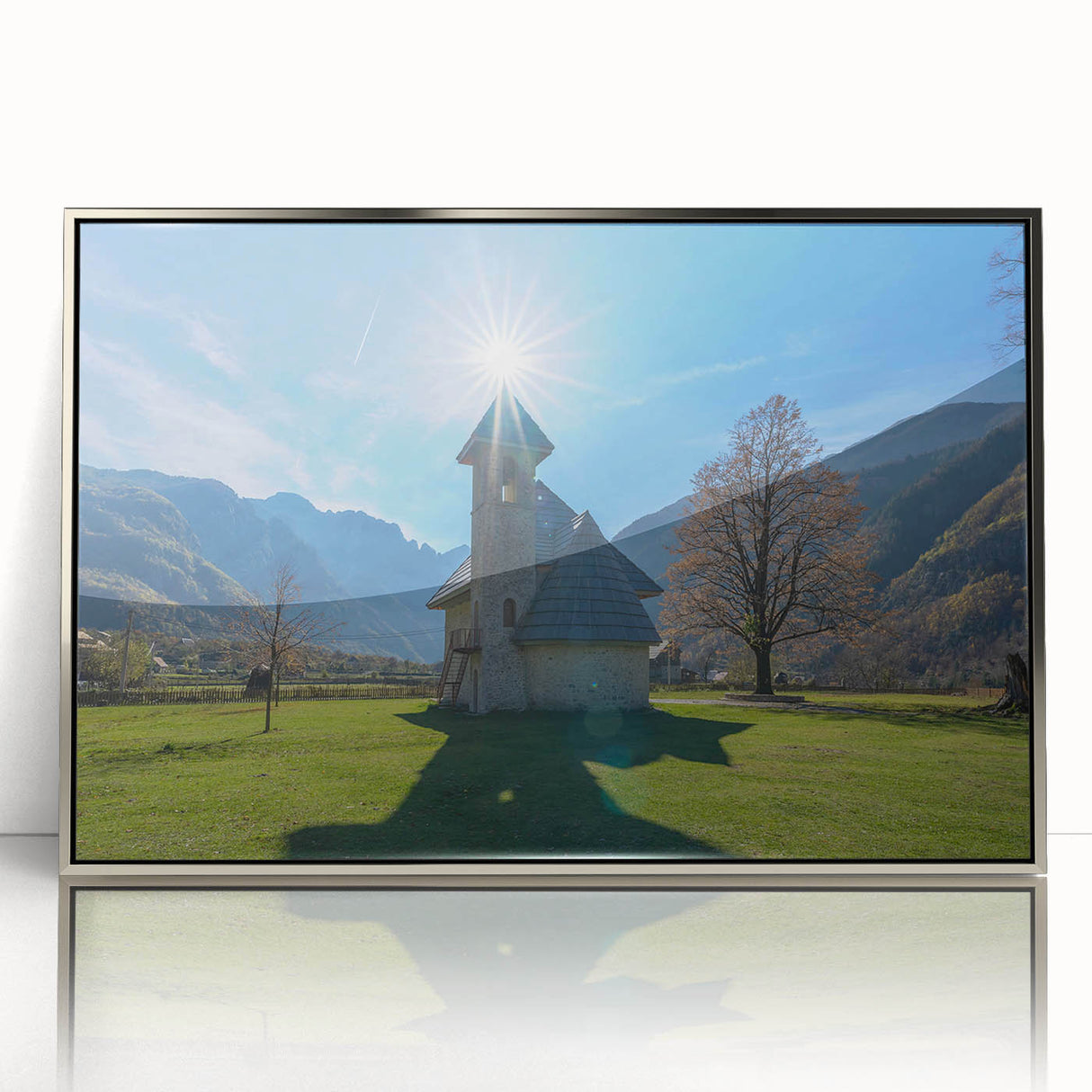 Art Deco poster of an Albanian landscape in silver framed acrylic, featuring muted earth tones.