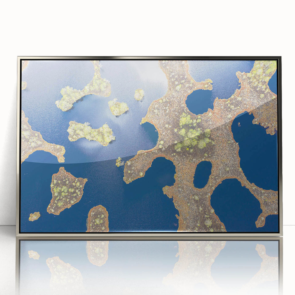 Large art print of a European Estonian scenery in muted green and blue tones, framed in silver acrylic.