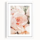 Abstract art print depicting spring, with vibrant green and soft pink tones on a white framed canvas.