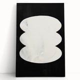 Abstract minimalist wall art on stretched canvas, featuring soft beige and gray tones, elegantly leaning against a white wall, adding a touch of modern decor.