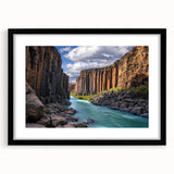 Framed landscape artwork showcasing dramatic cliffs against a serene sky, featuring a sleek black mat that enhances the visual appeal, ideal for modern home decor.