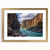 Framed landscape artwork showcasing dramatic cliffs in gold matting, perfect for home decor. This wall piece adds elegance and depth to any room setting.