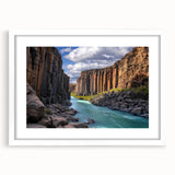 Framed landscape artwork showcasing dramatic cliffs with a white mat, ideal for home decor. Perfect for adding a touch of nature to living spaces.
