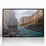 Framed acrylic artwork showcasing a stunning landscape scene of cliffs against a vibrant sunset, featuring a sleek black frame to enhance decor aesthetics.