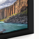 Close-up of a stunning framed canvas depicting dramatic cliffs and vibrant landscapes, showcasing rich colors and intricate textures, ideal for home decor.