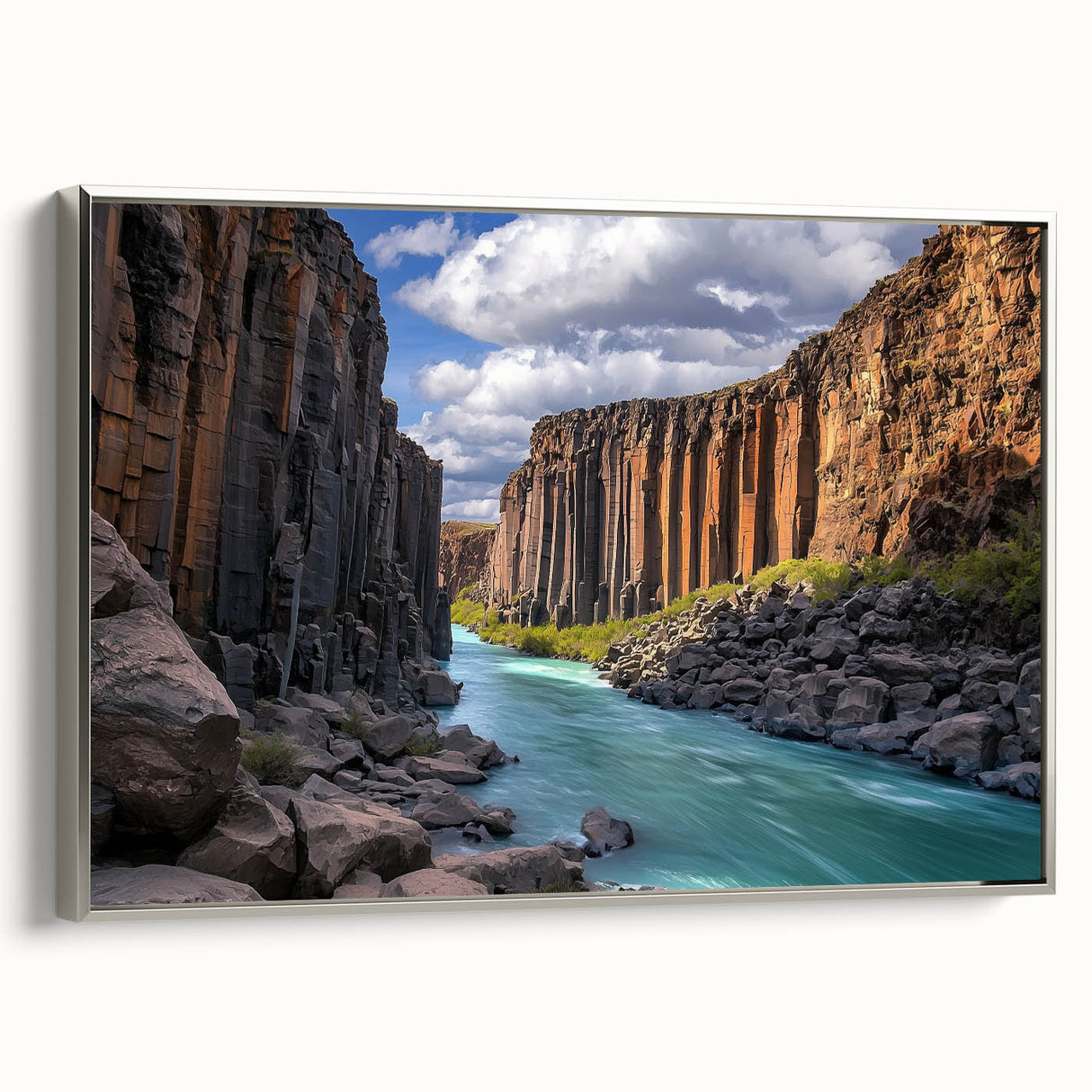 Framed canvas artwork depicting a stunning landscape of rugged cliffs, showcasing vibrant colors and intricate details, with a sleek silver frame enhancing its elegance. Perfect for adding a touch of nature-inspired decor to any space.