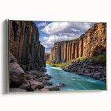 Framed canvas artwork depicting a stunning landscape of rugged cliffs, showcasing vibrant colors and intricate details, with a sleek silver frame enhancing its elegance. Perfect for adding a touch of nature-inspired decor to any space.