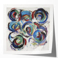 Colorful abstract splatter art print on glossy canvas, showcasing vibrant hues of blue, pink, and yellow, ideal for modern home décor and artistic displays.