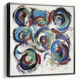 Framed canvas artwork displaying abstract splatters in vibrant colors, set against a sleek black frame, showcasing a modern artistic style ideal for contemporary decor.