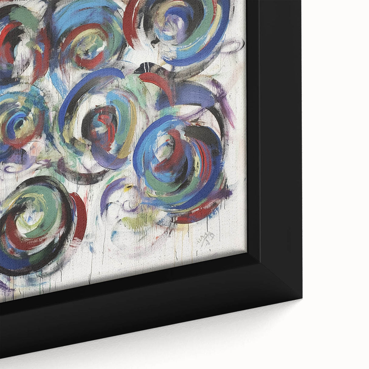 Close-up of a framed canvas artwork showcasing vibrant abstract splatters in shades of blue, yellow, and red, ideal for modern home decor.