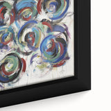 Close-up of a framed canvas artwork showcasing vibrant abstract splatters in shades of blue, yellow, and red, ideal for modern home decor.