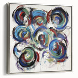 Framed canvas artwork showcasing abstract splatters in vibrant colors, set in a sleek silver frame, ideal for modern home decor and creative spaces.
